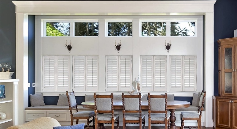 Destin dining room with shut plantation shutters.